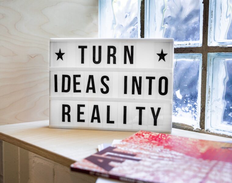 white and black wooden quote board