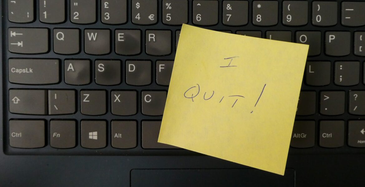a yellow notepad on a keyboard