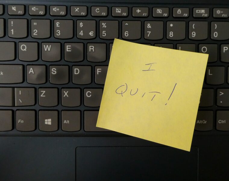 a yellow notepad on a keyboard