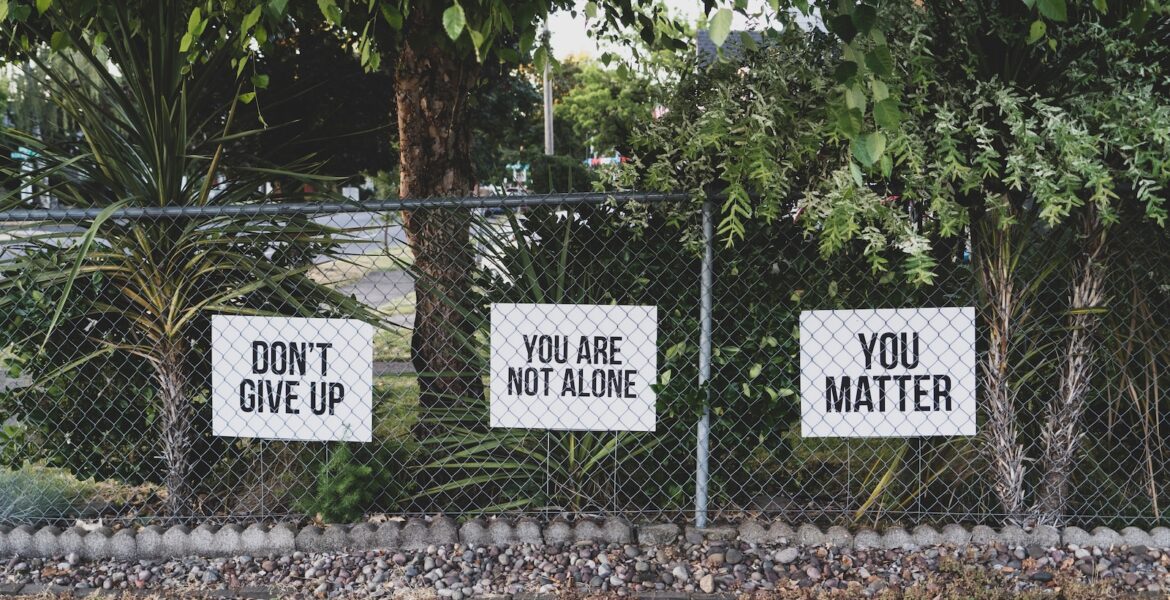 don't give up. You are not alone, you matter signage on metal fence