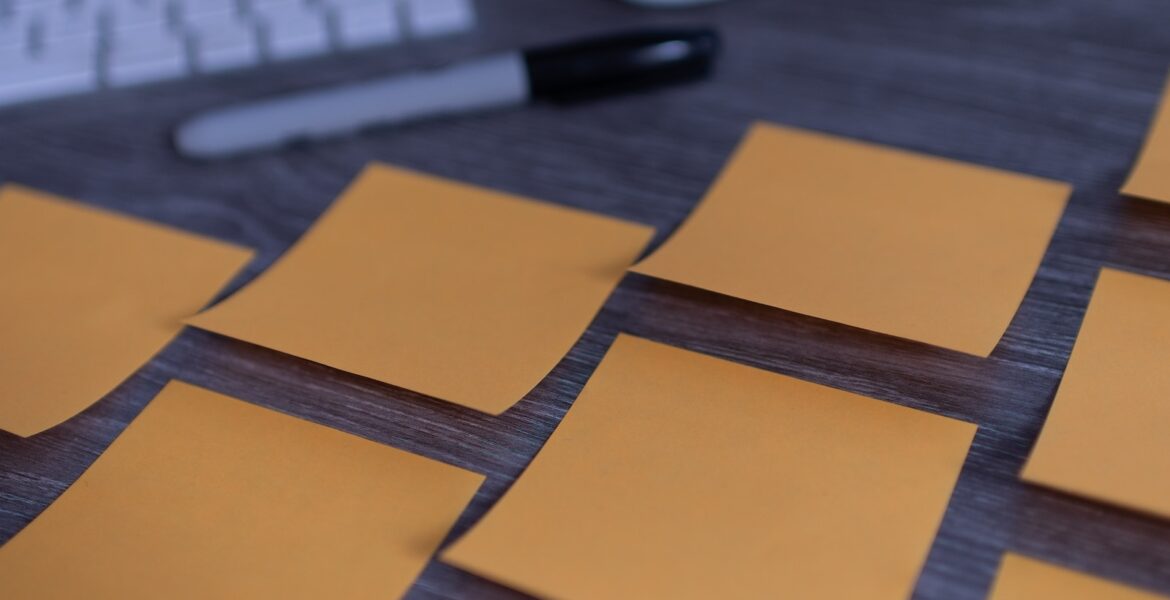 orange sticky notes on silver imac
