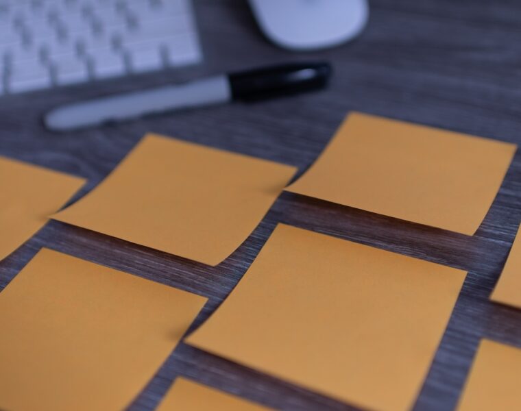 orange sticky notes on silver imac