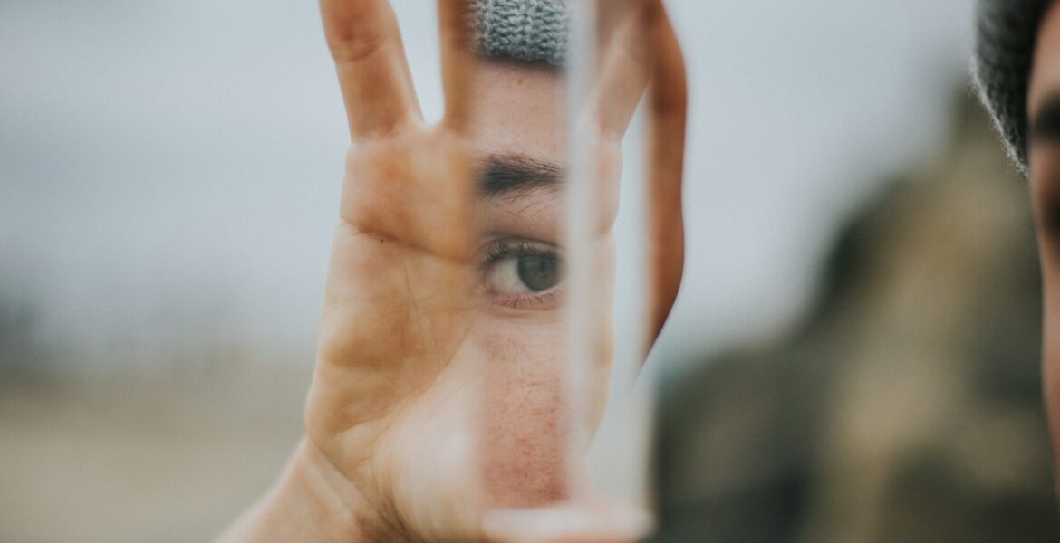 shallow focus of person holding mirror