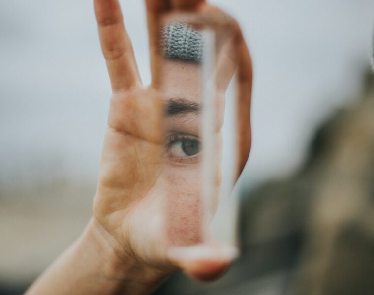 shallow focus of person holding mirror